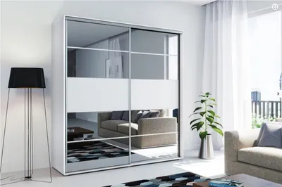 A modern living room with a large mirrored wardrobe, a floor lamp, and a sofa.