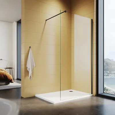 A modern bathroom with a walk-in shower, a towel hanging on the wall, and a view of the ocean through a large window.