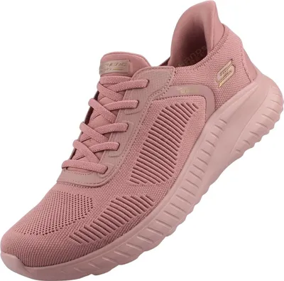 Das Bild zeigt einen rosa Freizeitschuh der von der Seite betrachtet wird. Der Schuh hat ein schlichtes Design mit einer charakteristischen Form und einer auffälligen Farbe.