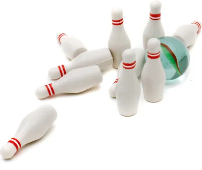 A mini bowling set with pins scattered and a marble-like bowling ball.
