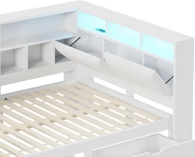 A close-up view of a white platform bed frame with integrated storage and LED lighting.