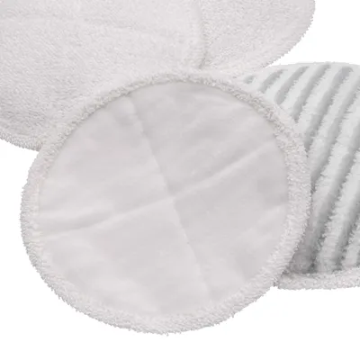 A close-up view of several round microfiber cleaning pads, some plain white and one with gray stripes.