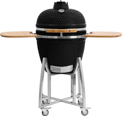 A black ceramic kamado grill on a silver stand with wooden side shelves, presented against a white background.