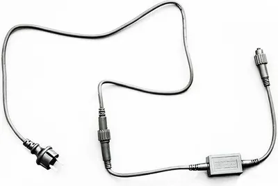A gray cable with multiple connectors and a small rectangular box is laid out on a white background.