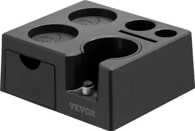 A black multi-functional espresso tamper station with various compartments and a small drawer.