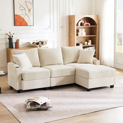 A modern living room with a beige sectional sofa and ottoman.