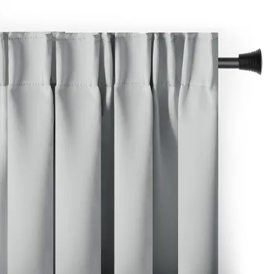 A close-up view of light gray curtains hanging from a curtain rod.