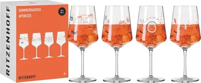 A set of four aperitif glasses filled with an orange beverage, presented next to their packaging.