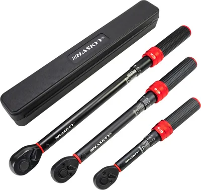 Three torque wrenches of different sizes are laid out diagonally on a white background, with a black storage case positioned above them.