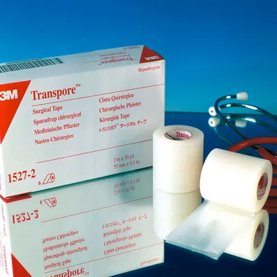 A product shot of medical tape and its packaging, with a stethoscope in the background.