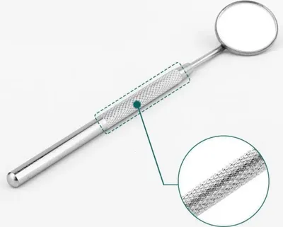 A dental mirror with a magnified view of its textured handle.