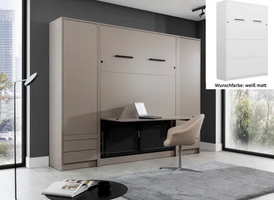 A murphy bed with a desk integrated into the front, set up in a modern room with a window and a chair.