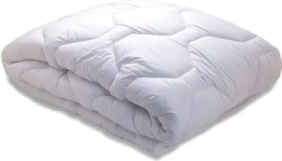 A white quilted comforter folded and lying on a white surface.