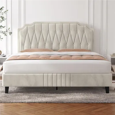 A beige upholstered bed with a tufted headboard is shown in a bedroom setting.