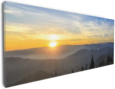 Produktbild von Wallario Premium Leinwandbild Sonnenaufgang über dem Schwarzwald in Größe 30 x 75 cm