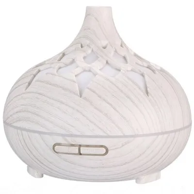 A white wood-grain aroma diffuser with a decorative cut-out top.