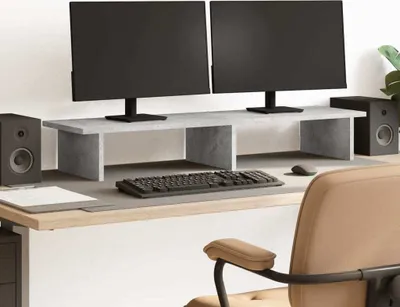 A desk setup with dual monitors on a stand, keyboard, mouse, and speakers.