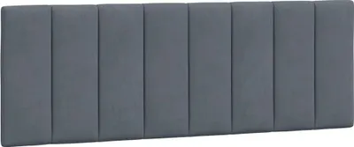 A dark gray upholstered headboard with vertical tufting.