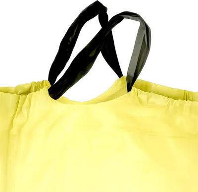 A close-up view of the top of a yellow trash bag with black handles.