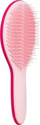 A pink hairbrush on a white background.