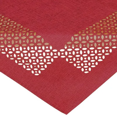 A close-up view of a red tablecloth with a decorative cut-out pattern.