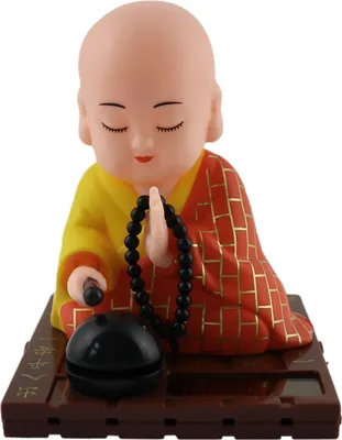 A solar-powered Wackelfigur (wobble figure) of a Buddha monk.