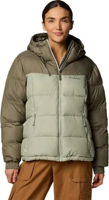 A woman wearing a green and brown puffer jacket.