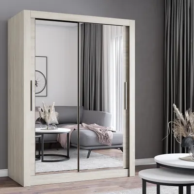 A wardrobe with mirrored doors in a modern living room setting, reflecting a sofa and a coffee table.