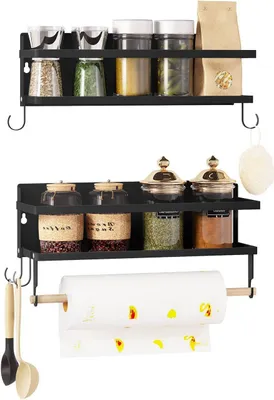 Two black metal shelves displaying various kitchen items like spice jars and a paper towel holder.