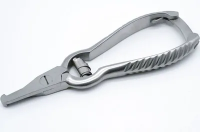 A close-up, studio shot of a pair of metal dog nail clippers against a white background.