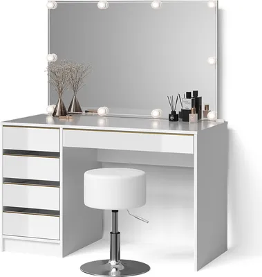 A white vanity table with a large mirror and LED lights, a white stool, and decorative items on the table.