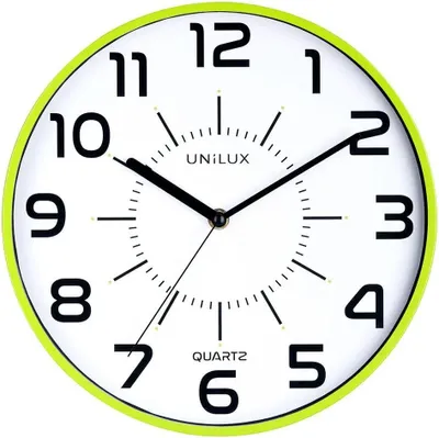 A close-up view of a wall clock with a green frame.