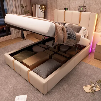 A bed with its storage compartment open, revealing stored items. The bed has a beige upholstered frame and headboard with LED lighting.
