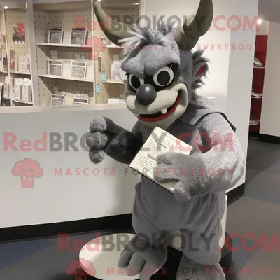 Immagine prodotto di Personaggio mascotte REDBROKOLY di un diavolo grigio vestito con pantaloncini e occhiali da lettura