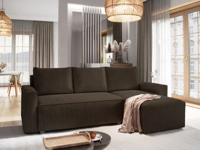 A modern living room with a brown sectional sofa, a coffee table with a tray, and large windows with curtains.