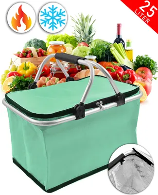 A green picnic basket filled with various fruits and vegetables, with a bottle of wine and other items in the background.