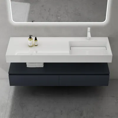 A modern bathroom vanity with a white countertop and integrated sink, set against a gray tiled wall.