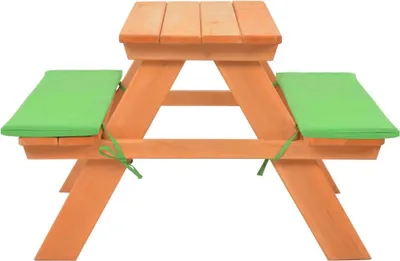 A wooden children's picnic table with green seat cushions, shown from a side angle against a white background.