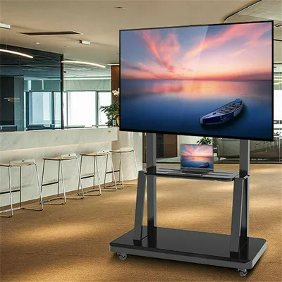 A modern office or lobby setting with a TV stand and a laptop.