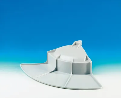 A gray plastic part, likely a lid or cover for a waste bin, is shown against a gradient blue and white background.