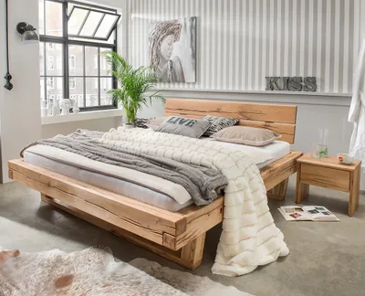 A bedroom scene featuring a wooden bed with bedding and a nightstand.