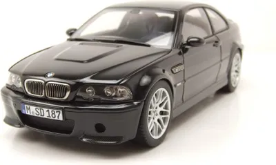 A black 1:18 scale model of a BMW M3 CSL E46 from 2003 is displayed on a white background.