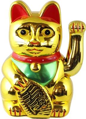 A golden lucky cat figurine with a red collar and green bib.