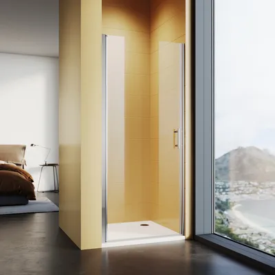 A modern bathroom with a shower enclosure next to a large window overlooking a coastal view.