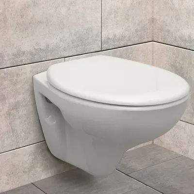 A wall-mounted toilet in a bathroom with tiled walls and floor.