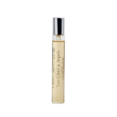 A small, clear glass vial of perfume with a silver cap, standing upright against a white background. The vial contains a golden liquid and has text printed vertically on its side.