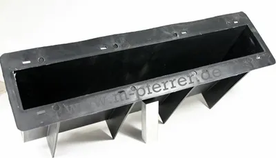 A black, wedge-shaped concrete formwork with metal supports, shown on a white background.