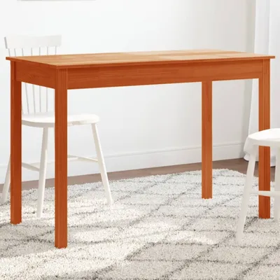 A wooden dining table with chairs in a room.