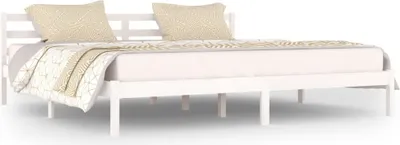 A white wooden bed frame with two pillows and a duvet.