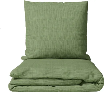 A folded green duvet and pillow, likely made of muslin fabric, are presented against a white background.